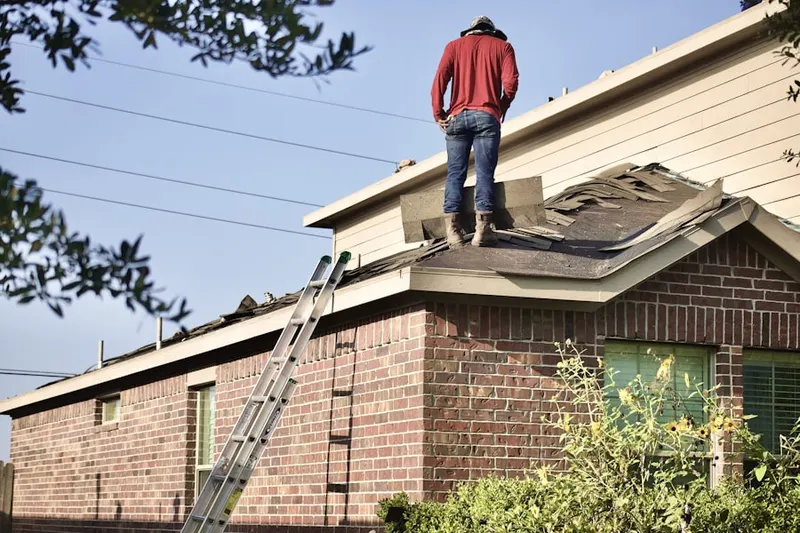 Professional roofer working on a residential roof in Ramsey Station